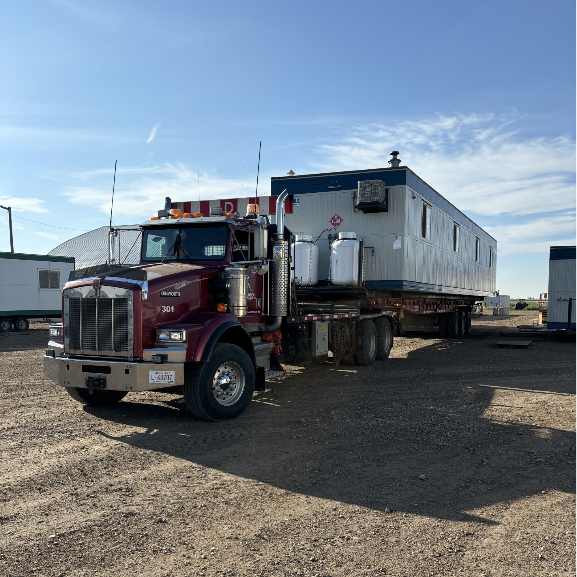 Enviroex winch tractor hauling office trailer to site