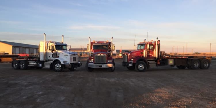 three tractors parked in a row with their grills all pointed toward each other