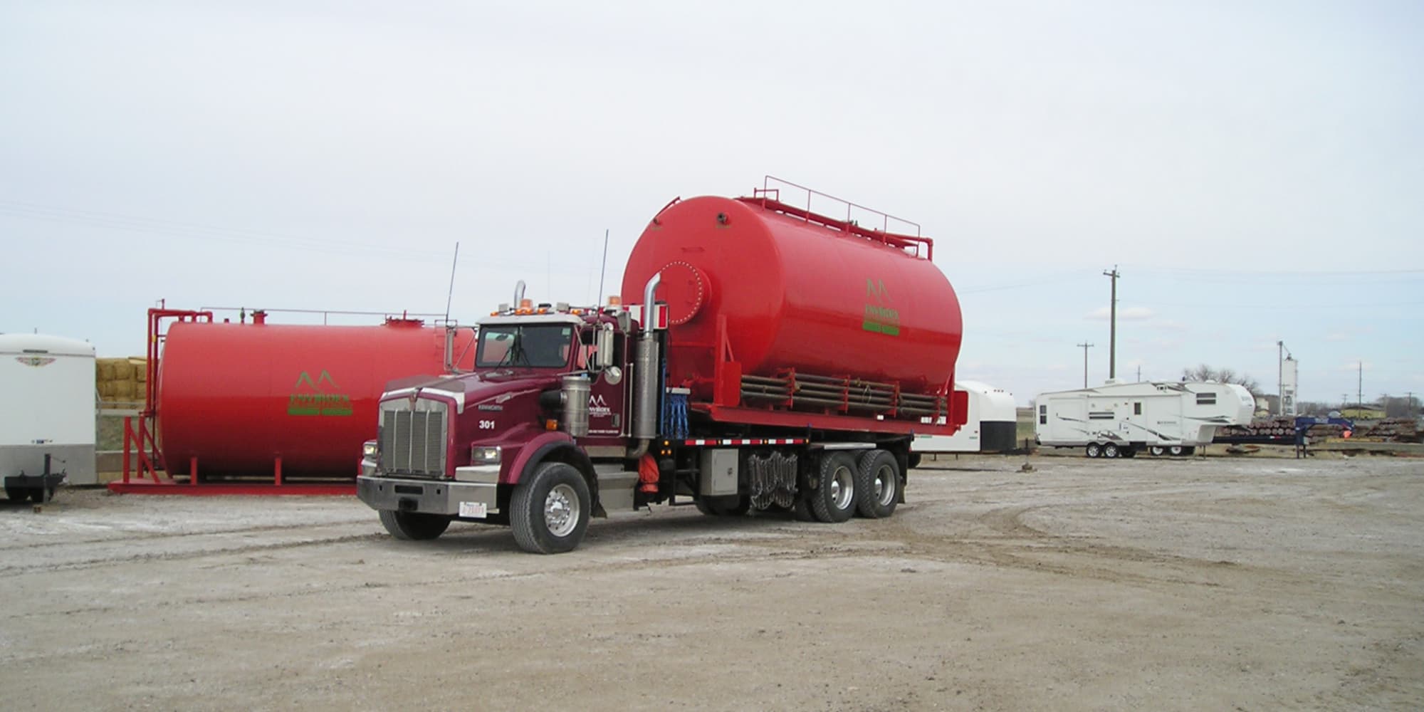 red tractor hauling 300 block back tank